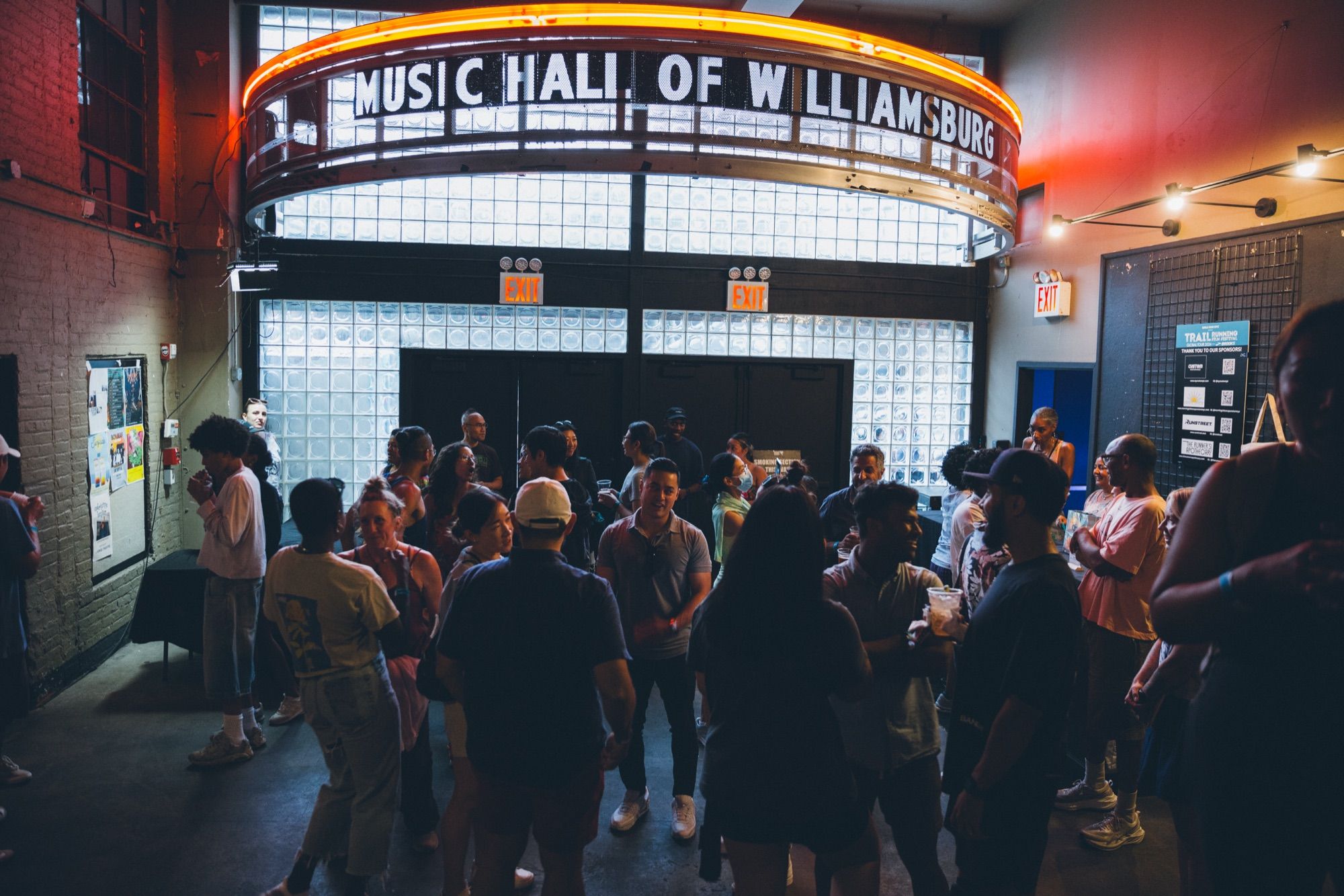 Guests gathering under the lit Music Hall of Williamsburg marquee before a screening